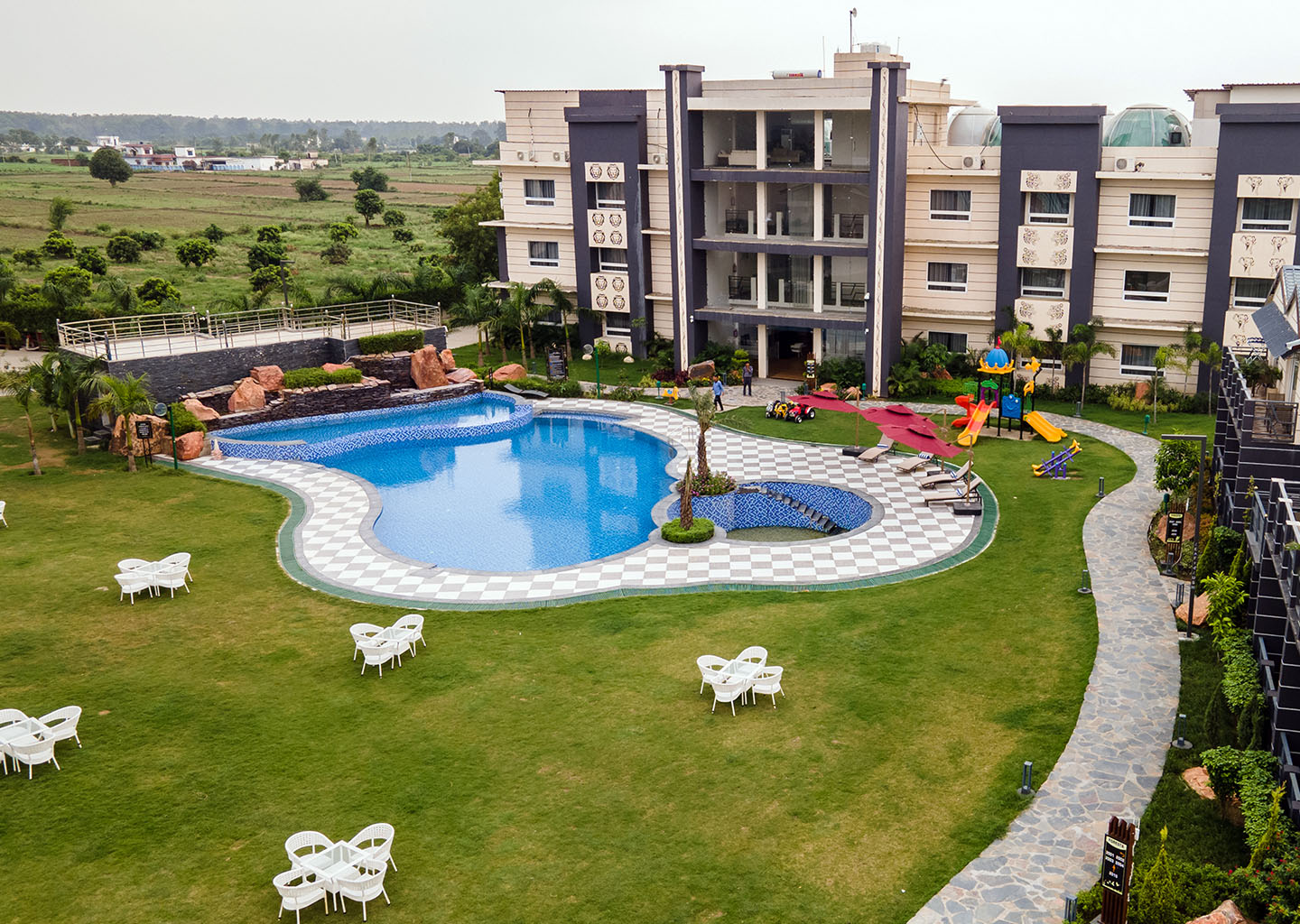 Leafylush swimming pool surrounded by landscaped gardens